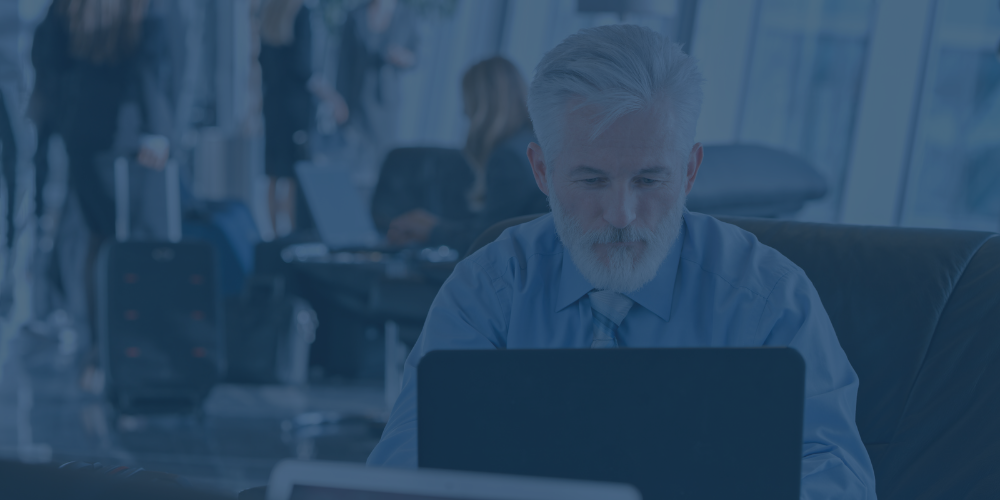 Businessman on his laptop at the airport
